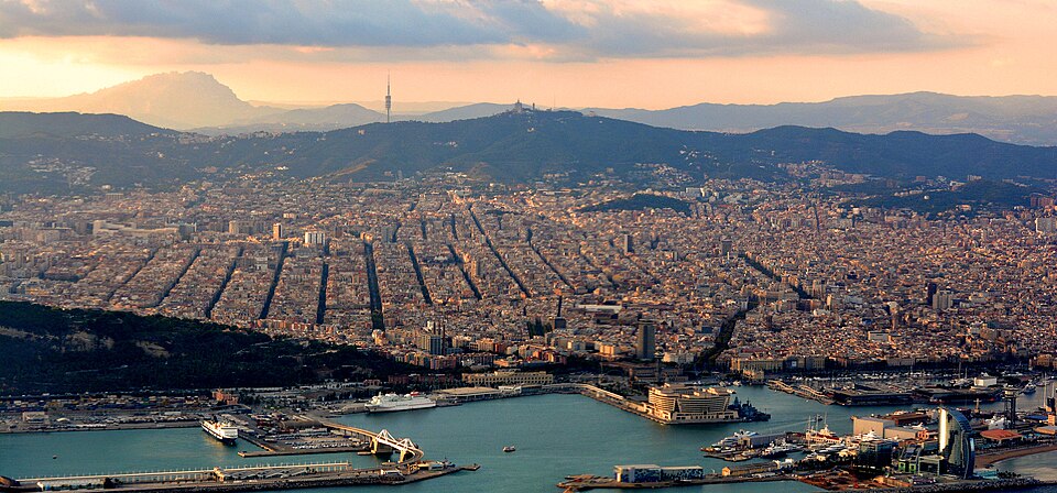 Aerial view of a coastal Mediterranean city at golden hour